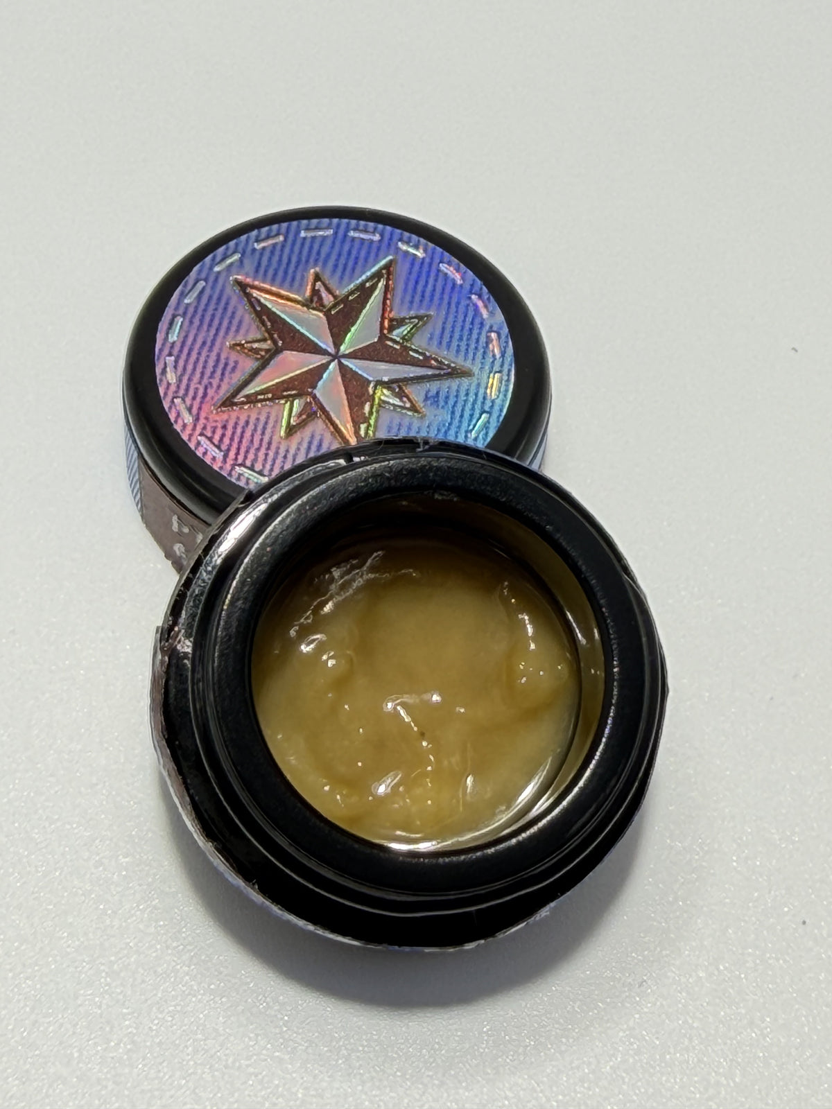 Starters Hash Black Bubblegum open jar with holographic star lid